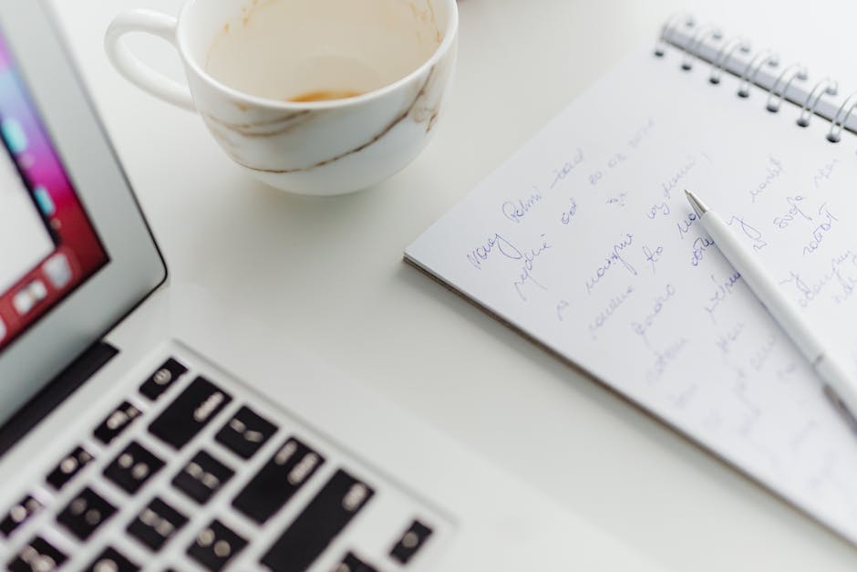 Bureau avec ordinateur portable, tasse de café et carnet de notes manuscrites, ambiance d'analyse de produit
